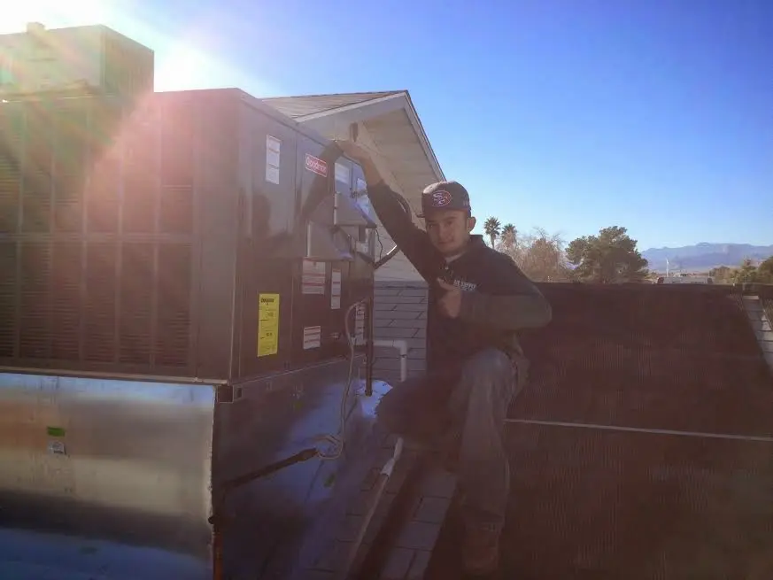 HVAC technician performing HVAC Inspection on a rooftop unit in Cedartown